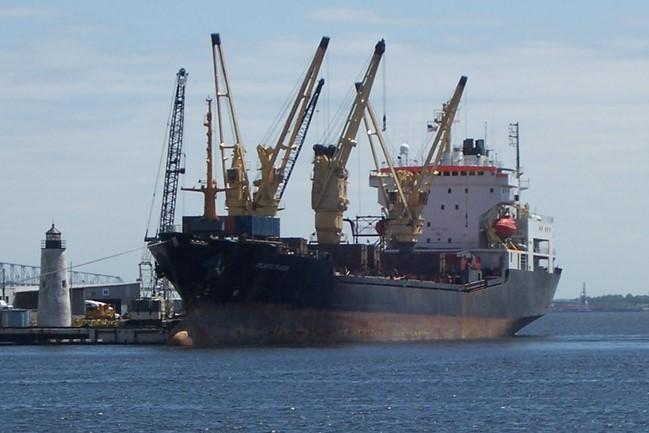 Photo of a shipping vessel docked at harbor