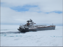 Photo of a freighter ship crossing icy Lake Superior
